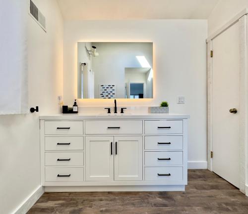 a white bathroom with a sink and a mirror at Dream Lakefront Escape + Beach/Ski/Golf near NYC in Highland Lakes