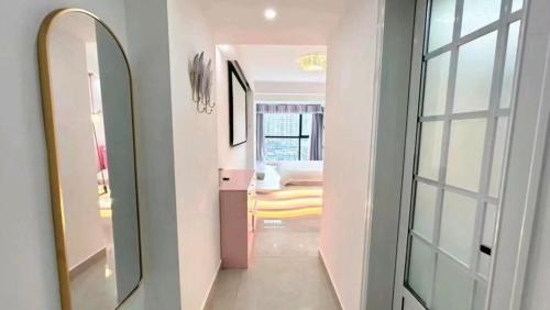 a hallway with a mirror and a room at Macaron in Zhangjiajie