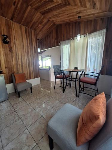 a living room with a couch and a table and chairs at Monteverde Cecropia Paradise in Monteverde Costa Rica