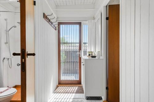a bathroom with a toilet and a glass door at 8220-Vordingborg-Solbaervej-6 in Vordingborg