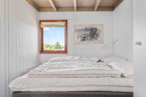 two beds in a white room with a window at 8220-Vordingborg-Solbaervej-6 in Vordingborg