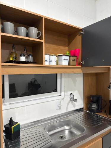a kitchen with a sink and a counter top at Casa Verde próxima a BR 290 in São Gabriel