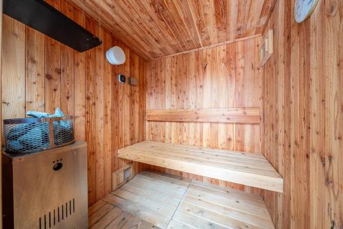 a wooden sauna with a wooden bench in a room at Hoshiyado Higashikawa in Higashikawa