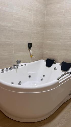 a white bath tub sitting in a room at Riva chalet in Badīyah