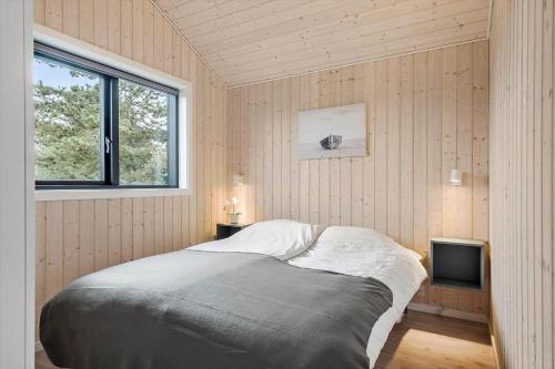 a bedroom with a bed and a window and a tv at OH419-Hadsund-Halvrebene-60 in Hadsund