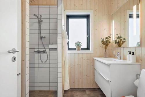 a bathroom with a white sink and a shower at OH419-Hadsund-Halvrebene-60 in Hadsund