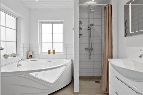 a white bathroom with a tub and a sink at OH362-Storvorde-Kongeornen-74 in Storvorde