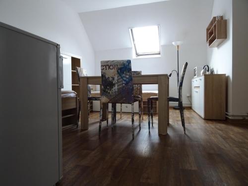a dining room table and chairs in a room at Penzion Eden Turnov in Turnov