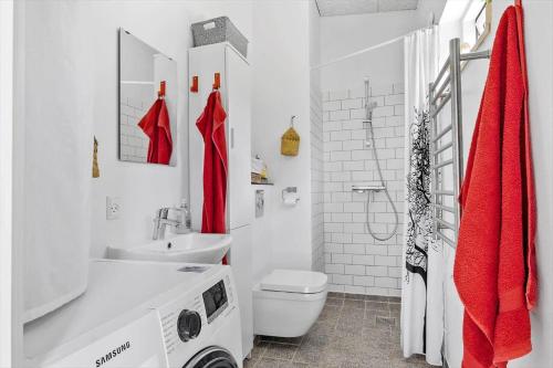 a white bathroom with a toilet and a sink at OH520-Hadsund-Sletten-132 in Hadsund