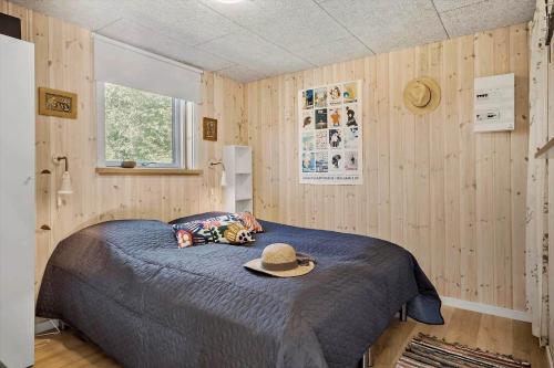 a bedroom with a bed with a hat on it at OH520-Hadsund-Sletten-132 in Hadsund