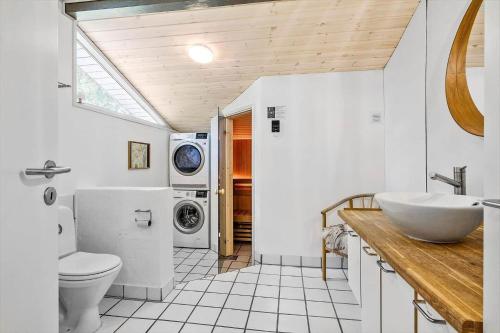 a bathroom with a sink and a washing machine at OH185-Hadsund-Sommerland-39 in Hadsund