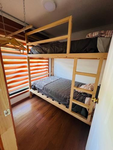 a room with bunk beds in a house at Oro y Miel in Callaqui