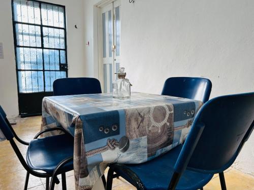a table with chairs and a bottle on top of it at Casa Playa Blanca in Progreso