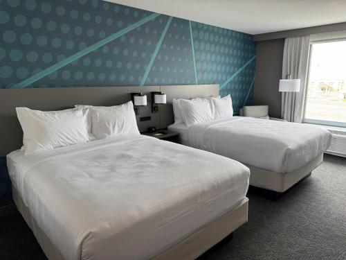 a hotel room with two beds and a window at Comfort Inn & Suites Colby in Colby
