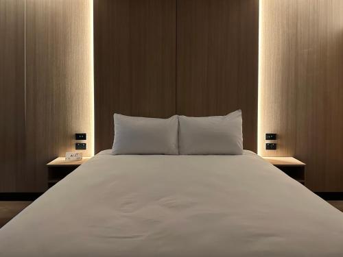 a large bed with white sheets and pillows at Avero in Rotorua