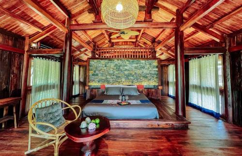 a bedroom with a bed in a wooden house at Mộc Châu House in Mộc Châu
