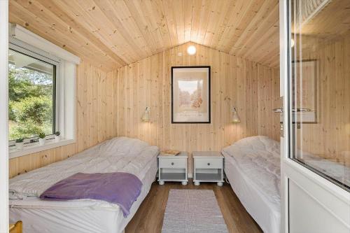 a bedroom with two beds and a window at OH525-Hadsund-Halvrebene-70 in Hadsund