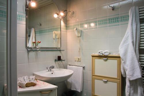 a bathroom with a sink and a mirror at Residence Salvan in Corvara in Badia