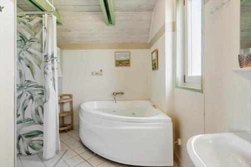 a white bathroom with a toilet and a sink at 300-Harboore-Fourmivej-29 in Harboør