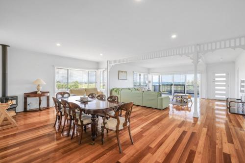 a living room with a table and chairs and a couch at Oceanfront Escape Kilcunda in Kilcunda