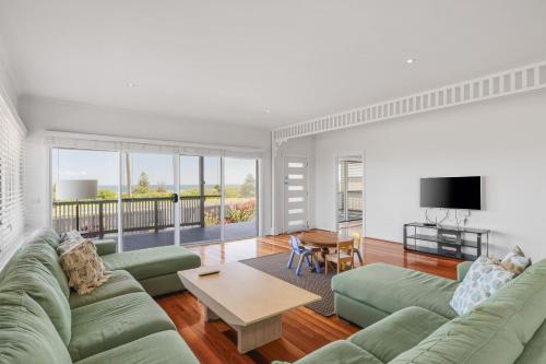 a living room with a couch and a table at Oceanfront Escape Kilcunda in Kilcunda