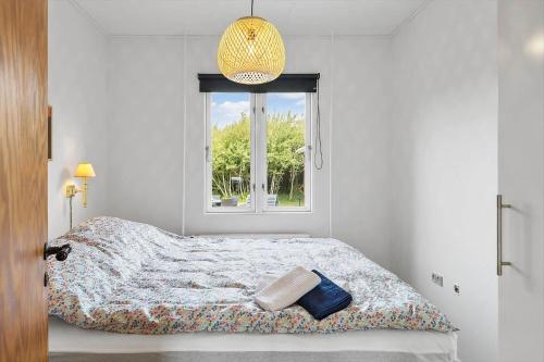 een witte slaapkamer met een bed en een raam bij 727-Thyboron-Magevej-10 in Thyborøn