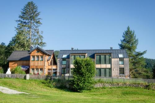 a house on a hill with a fence at Sportappartements in Bad Mitterndorf