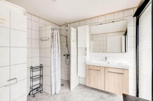 a white bathroom with a sink and a shower at 0005-Romo-Moritzvej-5 in Høm