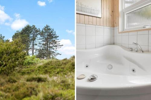 a bath tub in a bathroom with a view of a field at 0021-Romo-Ringvejen-74 in Høm