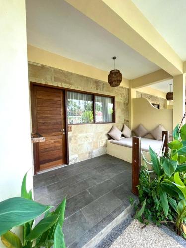 a bedroom with a bed in a room with plants at Mango Selong in Selong Belanak
