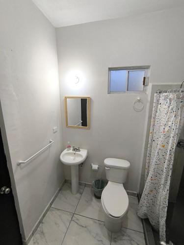 a bathroom with a toilet and a sink at Descanso y Comodidad en Reynosa in Reynosa