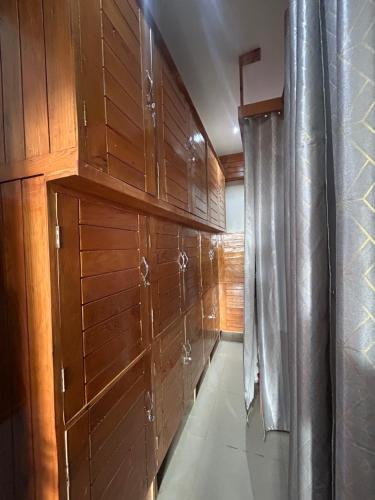 a row of wooden cabinets in a room at Dadhwal Zostel in Dharmsāla