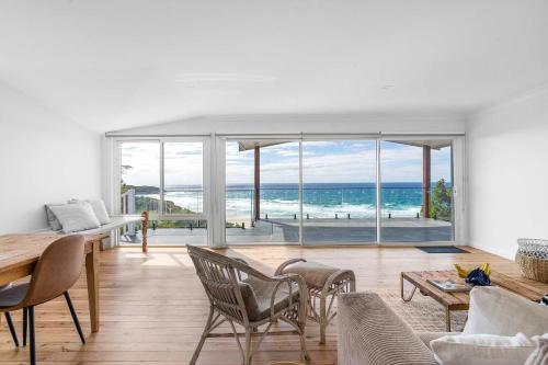 a living room with a view of the ocean at Ocean Overlook - Rennies Beach holiday haven in Ulladulla