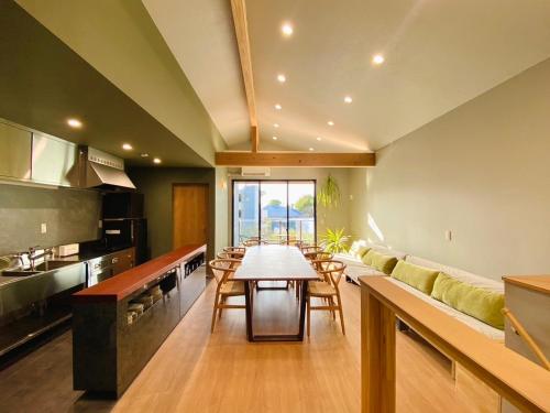 a kitchen with a table and chairs in a room at Fukuyado Sakurazaka in Fukuoka