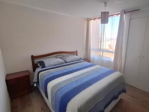 En eller flere senge i et værelse på Departamento Amoblado