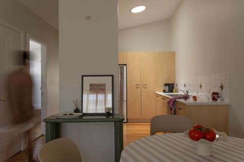 a room with a table and a kitchen with a tableablish at La Costa Shoal Bay in Shoal Bay