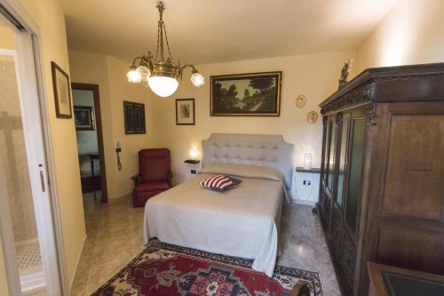 a bedroom with a bed and a chair at B&B Luxury in Lecce