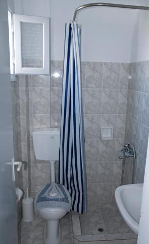 a bathroom with a shower with a toilet and a sink at Nicolas Antiparos in Antiparos Town