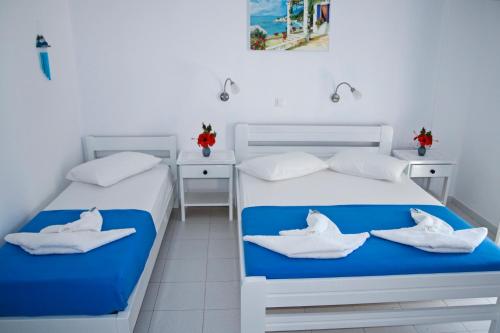 two beds in a room with white and blue at Nicolas Antiparos in Antiparos Town