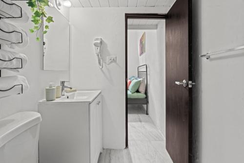 a white bathroom with a sink and a toilet at Old San Juan - Loft Balcony in San Juan