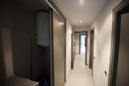 a hallway with a hallway leading to a hallway at WinTuWin Apartments in Rialp