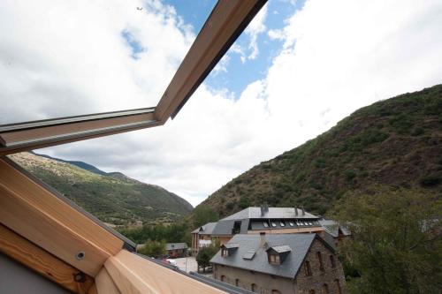 a view from a window of a building in the mountains at WinTuWin Apartments in Rialp