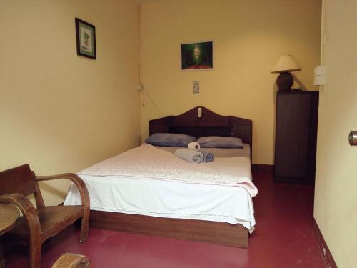 a bedroom with a bed with a teddy bear on it at Jimmy and Jeng Homestay in Chiang Mai