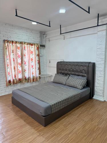 a bedroom with a large bed in a room at Eyka Studio Roomstay in Marang