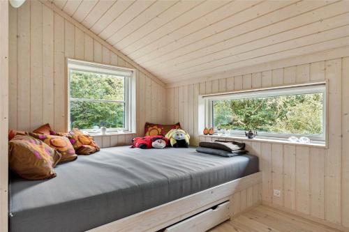 a large bed in a room with two windows at 11802-Nykobing-Sj-Gogetoften-10 in Nyrup