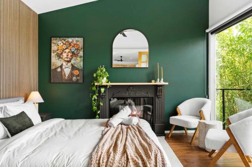 a green bedroom with a bed and a fireplace at 2BR plus Studio Pool & Spa Sleeps 8 in Daylesford