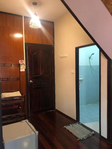 a room with a glass door and a mirror at Marissa Hotel in Haad Rin