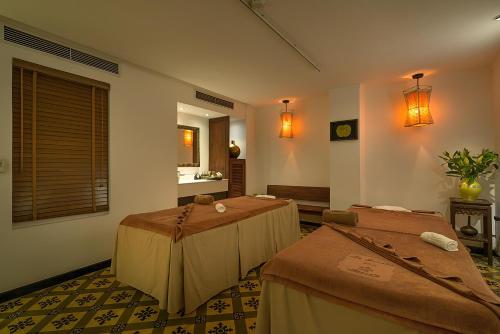 a room with two beds and a sink at La Nueva Boutique Hotel Hanoi & Spa in Hanoi