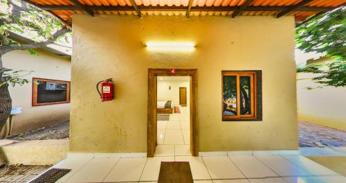 a door to a building with a fire hydrant at Tejas Gir Villas in Sasan Gir