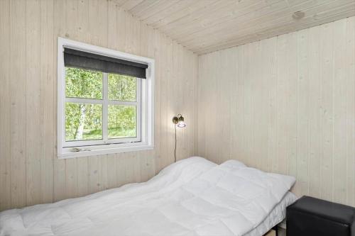a bedroom with a white bed and a window at LF21632-Spottrup-Rylevej-1 in Spottrup